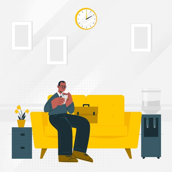 a man sitting on a yellow couch in front of a clock